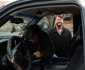 Jason Marion watches while Rodger Marion fiddles