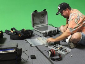 No, he's not going fishin'. Jason Marion selects the right cable or connector for recording the audio.