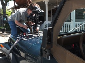 Rodger Marion attaches the camera to Paul's Jeep for a trip thru town.